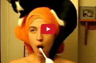 Lady Performs Morning Routine With Cat On Head