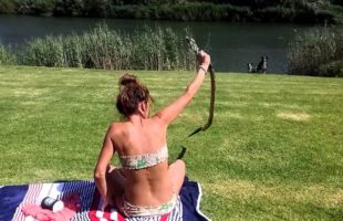 A Girl Catches a Cobra Fearlessly while Taking Sun Bath
