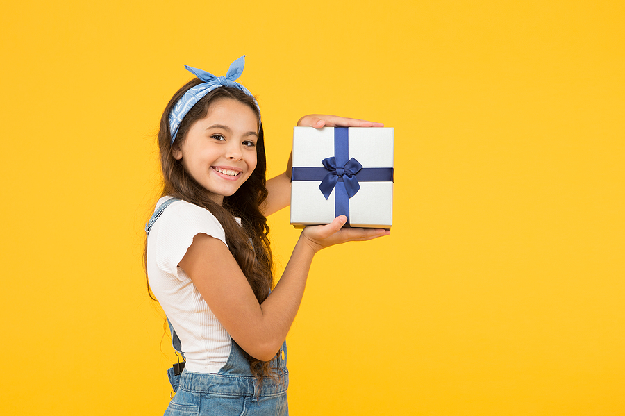 Child smiling happy hold gift box. Kid girl delighted gift. Unexpected surprise. Thank you. Celebrate birthday. Kid birthday gift. Extra bonus. Grateful for good gift. Surprise and present box.