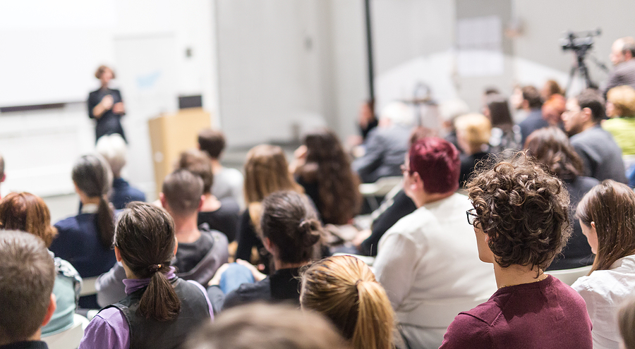How to Enjoy College Life as a Foreign Student Female Speaker Giving Presentation In Lecture Hall At University