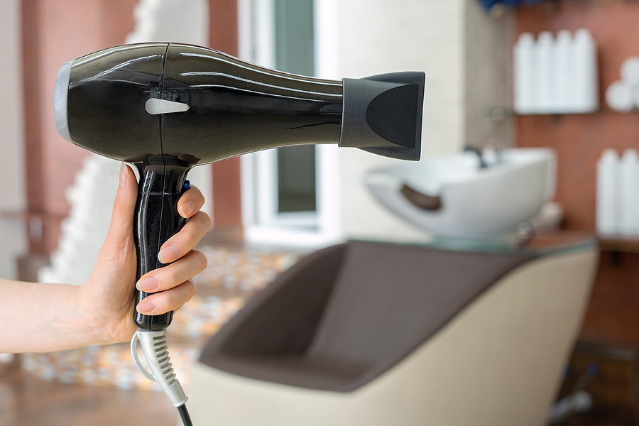 Best Ways To Use A Hair Dryer Diffuser  Hair dryer professional hair dresser tool in hairdressers hand against beauty salon interior background. Hair stylist work space. Beauty hairdressing salon, Barber shop, beauty services for hair
