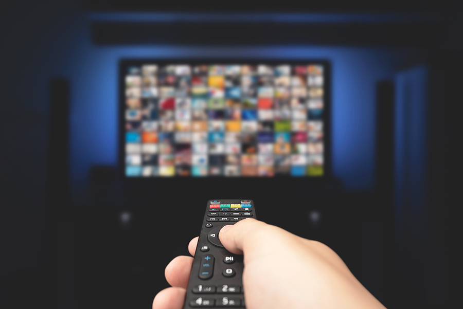 5 Cheaper Alternatives to Cable TV service Multimedia Video Concept On Tv Set In Dark Room. Man Watching Tv