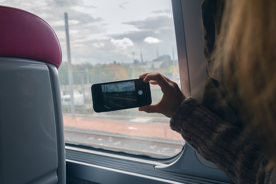Top 5 Best Things to do in Brisbane Woman Photographing With Cellphone Through Window While Travelin