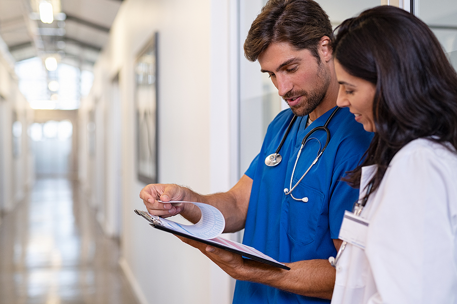 Why Hospitals Need Reliable Access Control Systems Team of doctors working together on patients file at hospital. M
