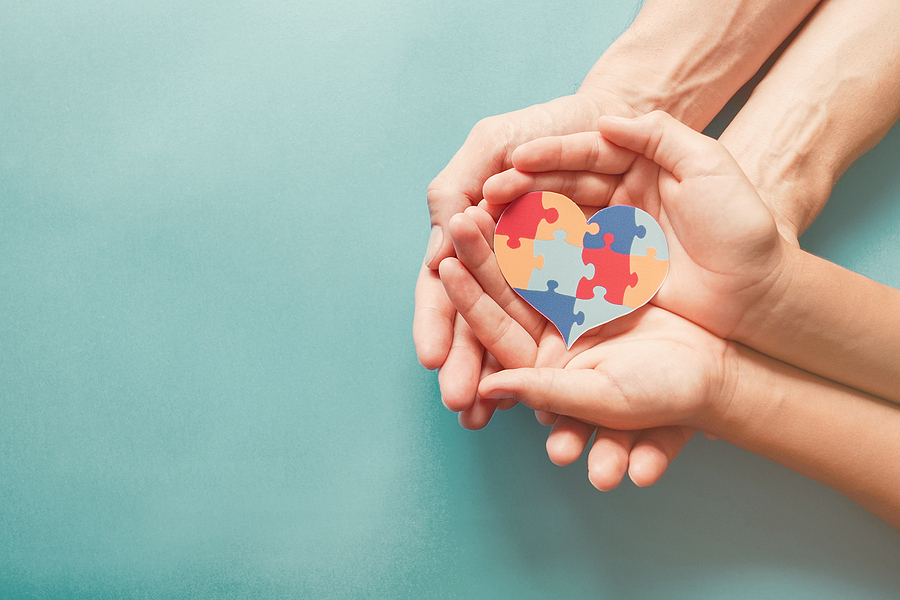 Progress in Understanding Autism Spectrum Disorder with Maurice Moses Adult And Chiild Hands Holding Jigsaw Puzzle Heart Shape, Autism