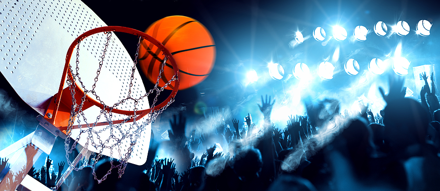 Beginners Guide to Fantasy Sports and All You Need to Know Hoop And Ball Illuminated By The Spotlights. Competition And Spo