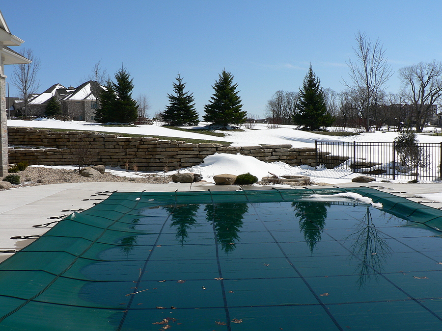 How To Safeguard Your Pool Cover In The Winter? Tree Reflections On Watery Pool Cover