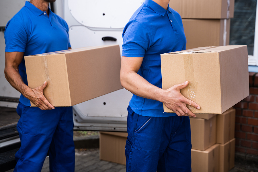 moving. Truck Movers Loading Van Carrying Boxes And Moving House