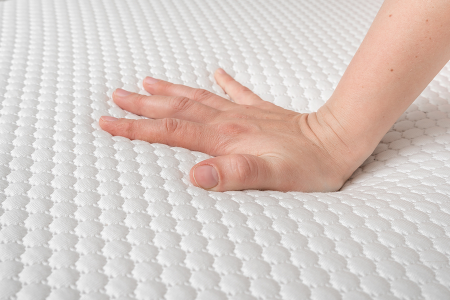 Sleep Tight: 7 Questions to Ask Yourself Before Buying a Mattress Woman Is Choosing New Mattress For Good Sleeping