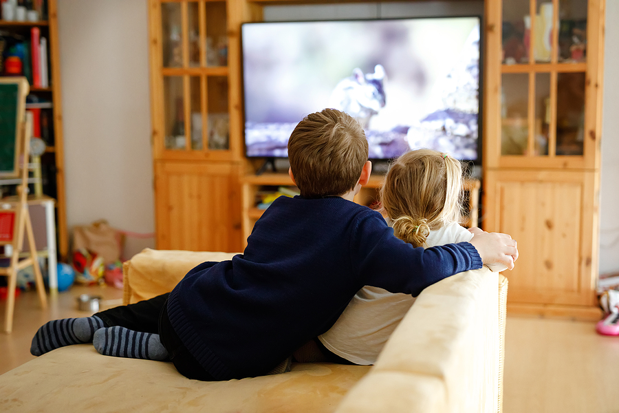 Cute Little Toddler Girl And School Kid Boy Watching Animal Movi