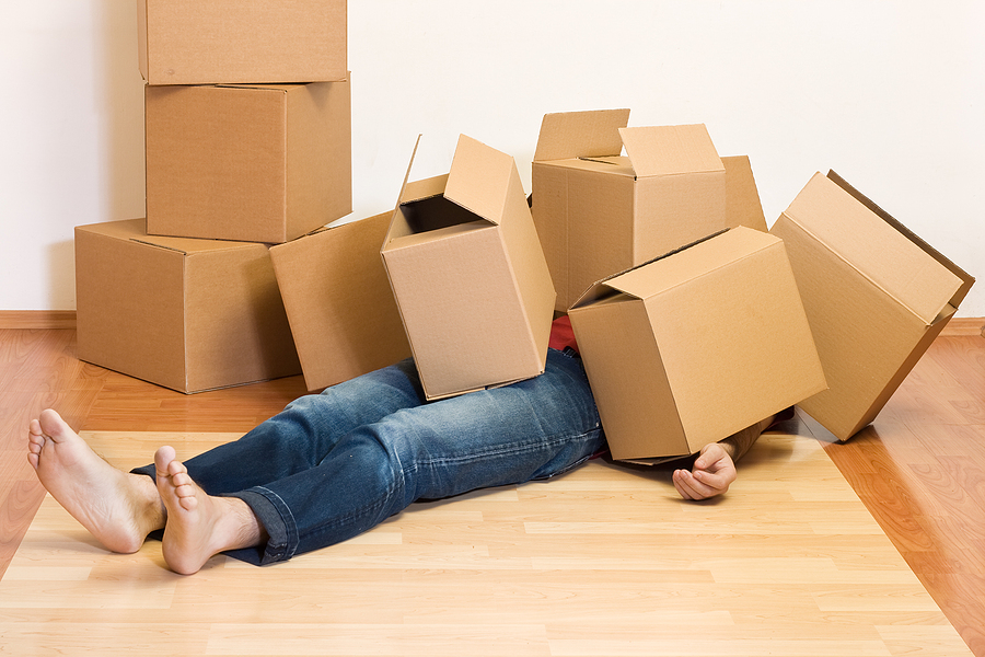 Packing Strategies to Simplify Your Move and Make Unpacking a Breeze packing unpacking Man covered by lots of cardboard boxes - moving concept