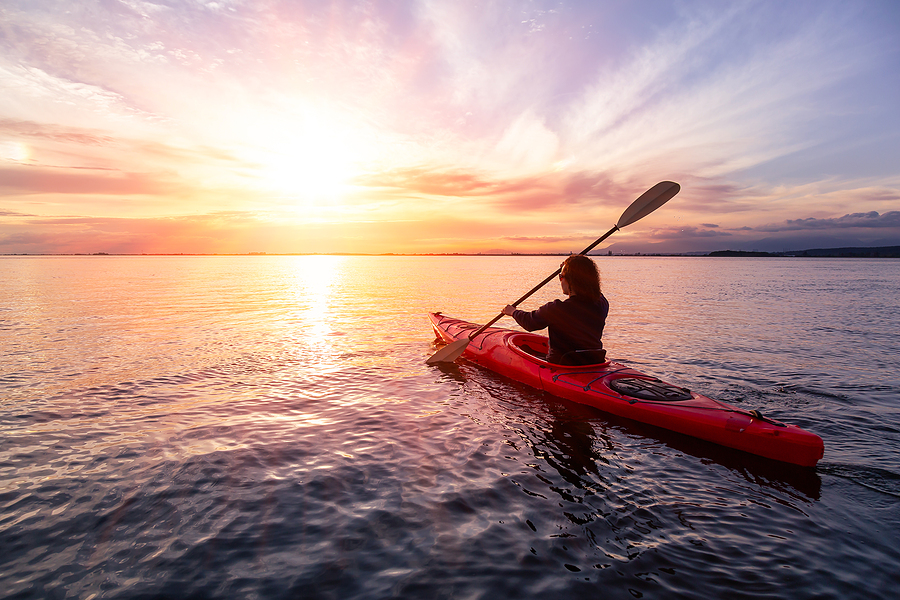 Explore Different Financing Ways With- Kayak Financing! Sea Kayaking In Calm Waters During A Colorful And Vibrant Sunset