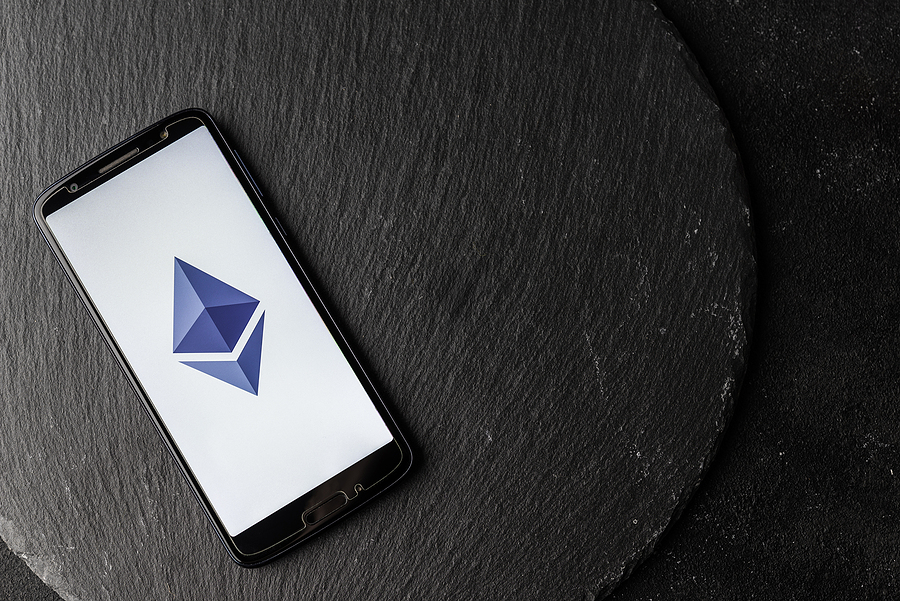 Everything you need to know about Ethereum Logo of Ethereum blockchain money cryptocurrency on screen of smartphone.