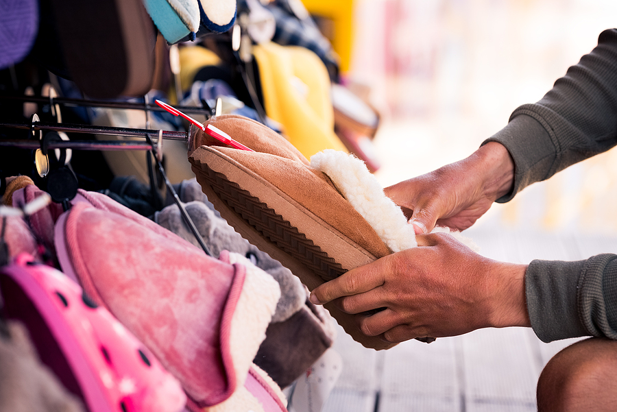7 Types of Promotional Product Buyers Man Choosing Warm Brown Home Slippers In The Shop.buying Slipper
