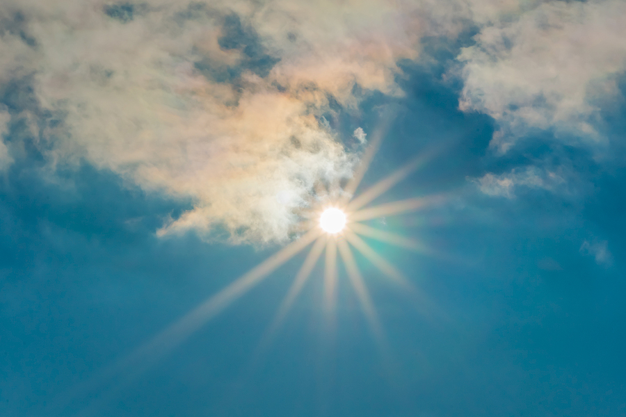 Style your eyes with all new Versace Sunglasses The sun in the blue sky under the clouds. Sunny day. Blue sky. Bright midday sun illuminates the space. Blue sky with clouds and sun reflection. The sun shines bright in the daytime in summer.