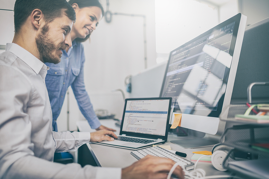 Is C# a Versatile Programming Language? — Areas of Use & Applicability Developing programming and coding technologies. Website design. Programmer working in a software develop company office.