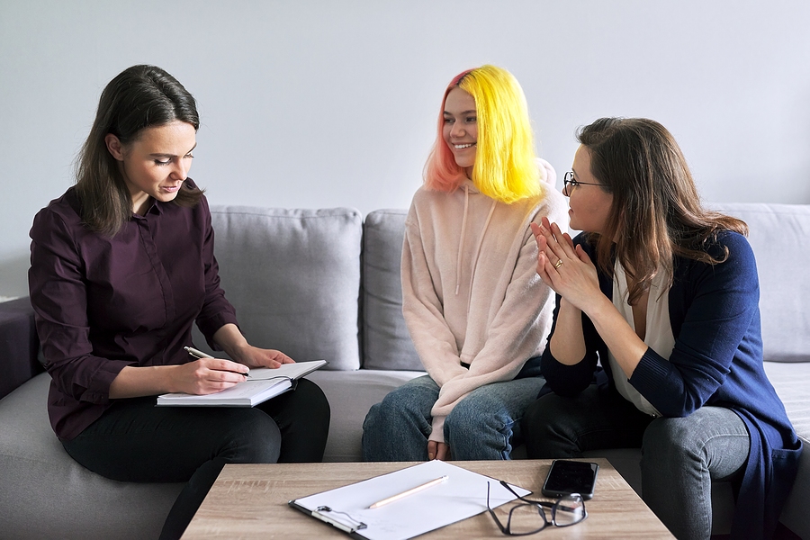 Social Work: Highlight How This Profession Benefits Society Social worker, psychologist, counselor at meeting with mature woman and her teenage daughter. Psychology, family mental health, adolescence problems, mother daughter child parent relationships