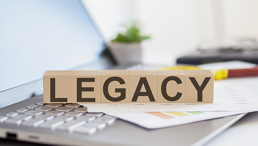 Importance of Leaving Behind a Digital Legacy Legacy Wooden Cubes With Letters On A Laptop Keyboardwith Charts