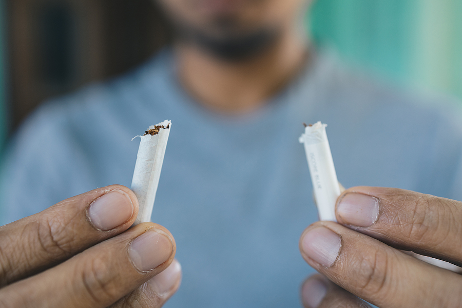 Men quit smoking, Young man holding broken cigarette in hands, Stop smoking cigarettes concept, No smoking