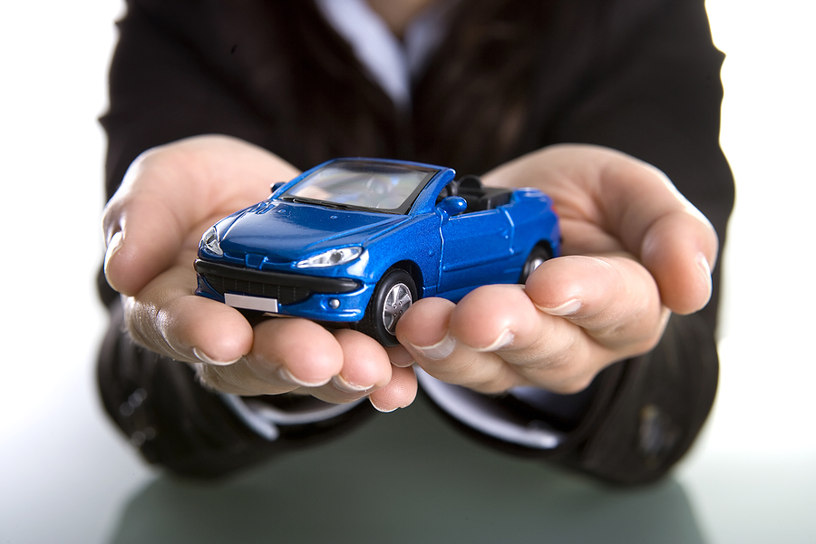 Can You Register a Car without Insurance in Oregon businesswoman holding car in the hands - insurance business concept