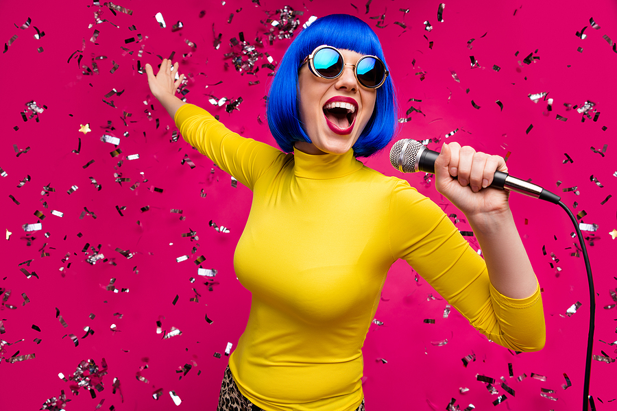 Is AliExpress Reliable for Wigs? Closeup photo of funny nice lady singer party night club microphone karaoke confetti falling wear specs yellow turtleneck blue wig isolated bright pink color background