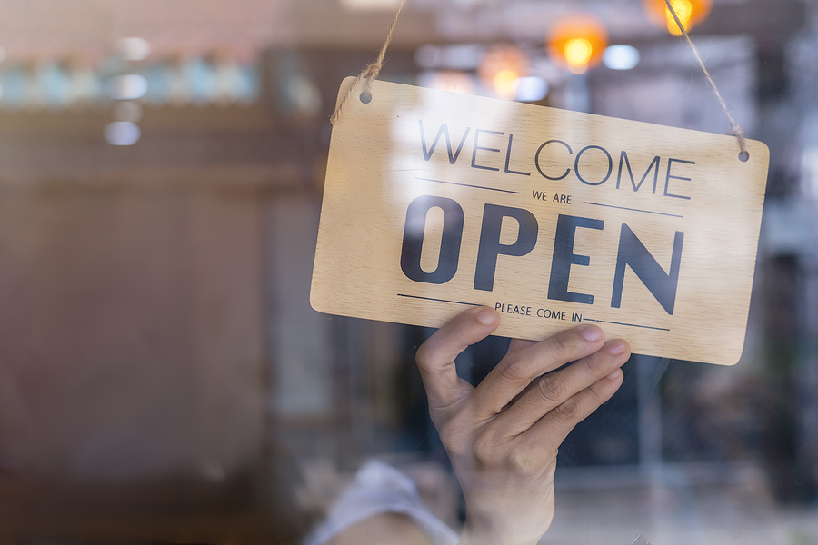 Best ways to use brand ambassadors Hand of asian owner retail ,coffee shop woman turning sign board to open. Protection to pandemic of coronavirus. Open store,restaurant or pub due to lockdown quarantine of covid-19.