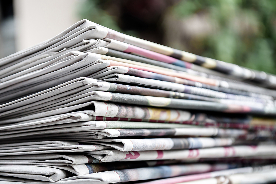 7 Advantages of print advertising Newspapers Folded And Stacked On The Table With Gardenor Green B