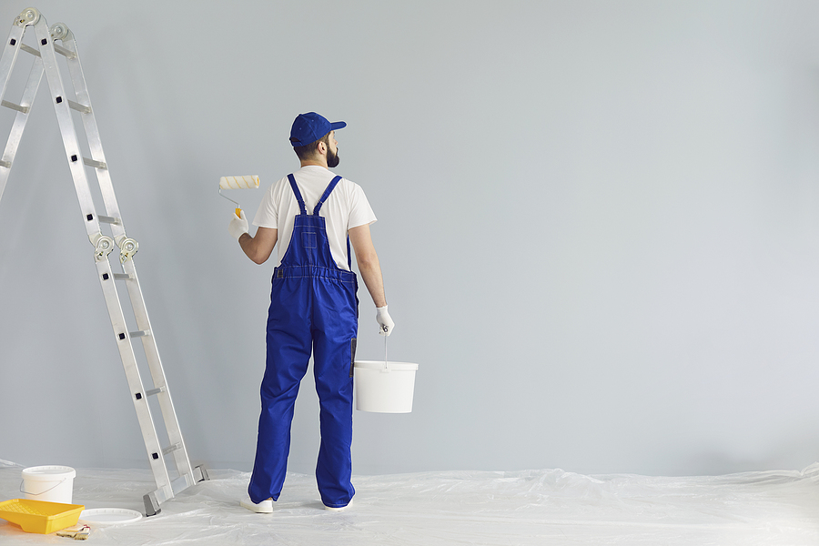 How To Renovate Your House on a Budget in 2023 Bearded Painter Contractor Preparing To Paint Wall