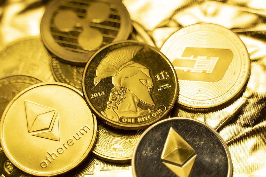 Gold crypto coins on a golden background. Trading on the cryptocurrency exchange. Cryptocurrency Stock Market Concept. Virtual money concept. Mining or blockchain technology. Business concept.