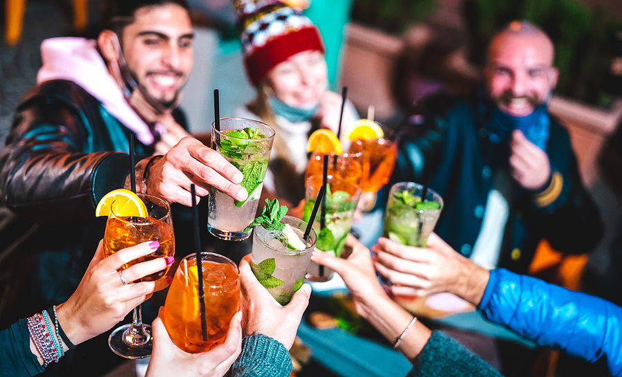 A Guide to Getting Ready for a Night Out Happy Friends Toasting Drinks At Night Bar With Open Face Mask –
