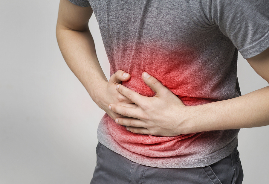 Sick man holding stomach, suffering from pain, diarrhea, indigestion problem
