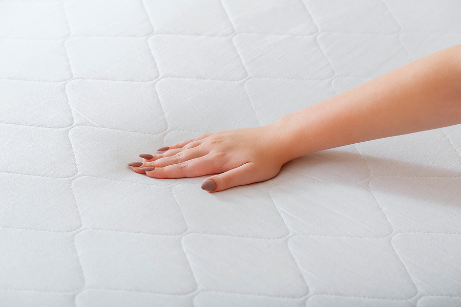 Memory Foam, Latex, or Hybrid - Choose the Best Mattress Based on Your Sleeping Habits Woman Choosing New Mattress. Female Hand Pressing Testing Mattre