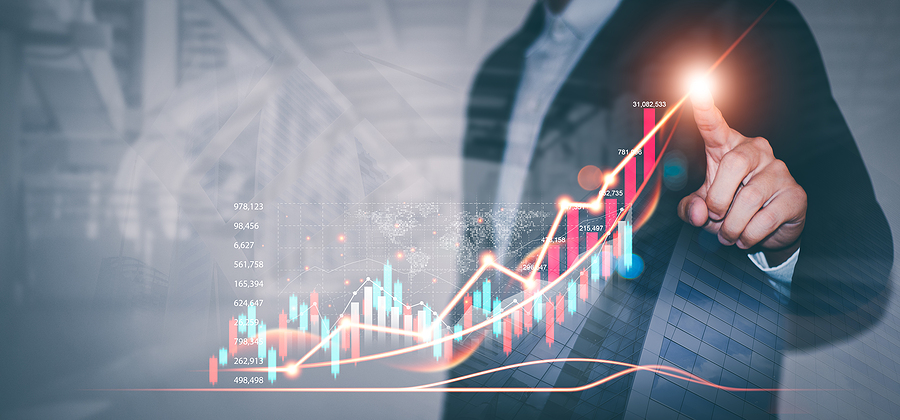Businessman draws graphs of business growth and analyzes financial and investment data, planning business, finance and investment strategies on Business finance background.