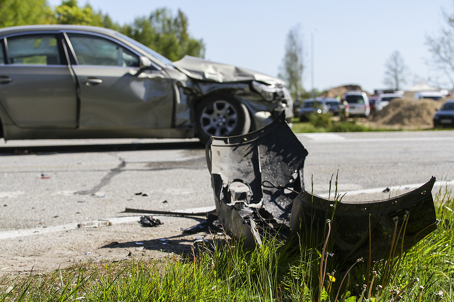 Car crash accident on the road, damaged car after collision is deployed against traffic. Front of car damaged by accident. Wreckage of car on the road