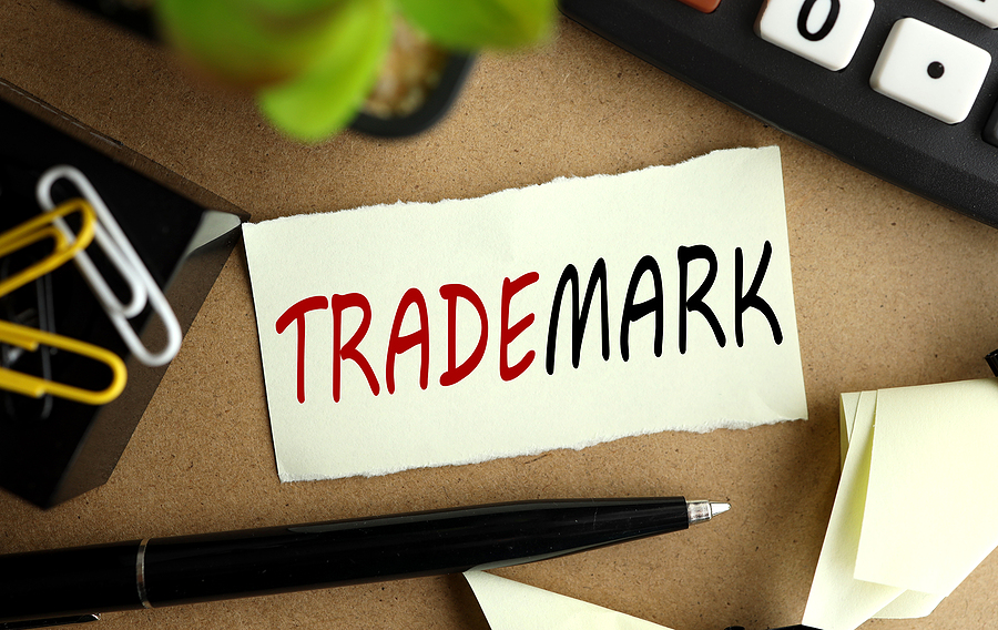 How To Start The Trademark Registration Process Trademark. Text On Yellow Sticker Near Calculator , Green Plant,