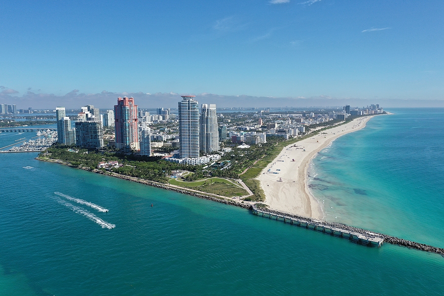 Aerial view of South Pointe Park and South Beach in Miami Beach, Florida with Port Miami and City of Miami skyline in background.