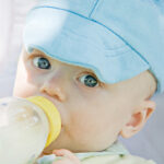 Infant Formula Little Baby Drinking out of a Bottle ** Note: Slight graininess, best at smaller sizes