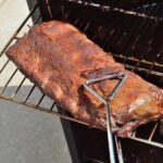 Deliciously Smoky: 5 Advantages of Using an Electric Smoker Removing Baby Back Ribs (Pork) From an Electric Barbecue Smoker