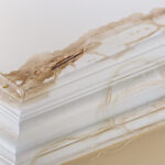 An Essential Guide to Water Damage Restoration in Toronto Peeling paint on an interior ceiling a result of water damage caused by a leaking pipe dripping down from upstairs a result of substandard plumbing completed by an unqualified plumber. A common house insurance claim.
