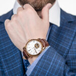 Class is timeless. Wristwatch worn on male arm wrist. Business wristwatch collection. Time management
