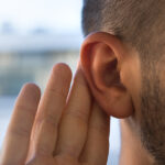 Music and Your Hearing: How to Enjoy Your Favorite Tunes without Damaging Your Ears Young man with hearing problems, hearing loss or hard of hearing