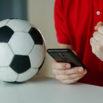 Gift Ideas for Fantasy Sports Fanatics Close up of happy young man celebrate winning of his sports bet. Concept of betting, gambling.