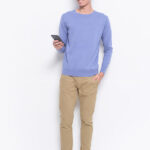 Top 3 Advantages of Buying Chino Men’s Pants Full size photo of young handsome man wearing blue sweatshirt ,khaki pants ,use cellphone answer sms messages have online conversation. Chino pants.