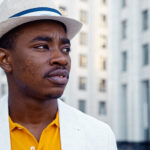 10 fedora hats for men to add to your collection Serious African American man in white suit with fedora hat looks