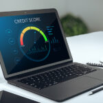 Does Your Credit Rating Matter For A Financially Stable Life? Find Answers Here! Close Up Of Creative Office Table With Credit Score Page On Lapt