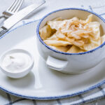 Dumplings With Potatoes On A Plate With Sour Cream