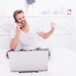 The Most Expected Online Video Games in 2022 Its a deal. Happy man make winner gesture in bed. Mobile communication. Phone conversation. Computer technology. Bet winner. Online betting. Virtual casino games.