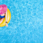 Beautiful Woman In Hat In Swimming Pool Aerial Top View From Abo