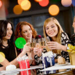 Portrait of attractive women clinking champagnes with each other during hen-party