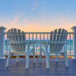 What Florida Lender Will do Foreign National Mortgage Loans? Empty Adirondack chair on a deck balcony overlooking the beach a